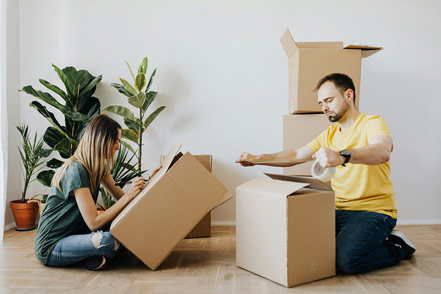 Calling it Splits - couple packing up boxes to move