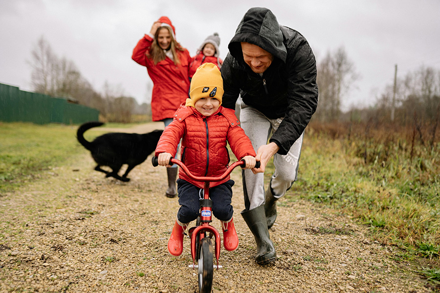 rethinking legacy May 2026 donor fund - dad pushing child on bicycle with mother, sibling and dog in background.