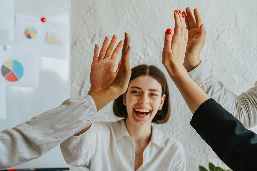 Lean On Us: Five Reasons to Connect with GPCF - business people "high-fiving" each other